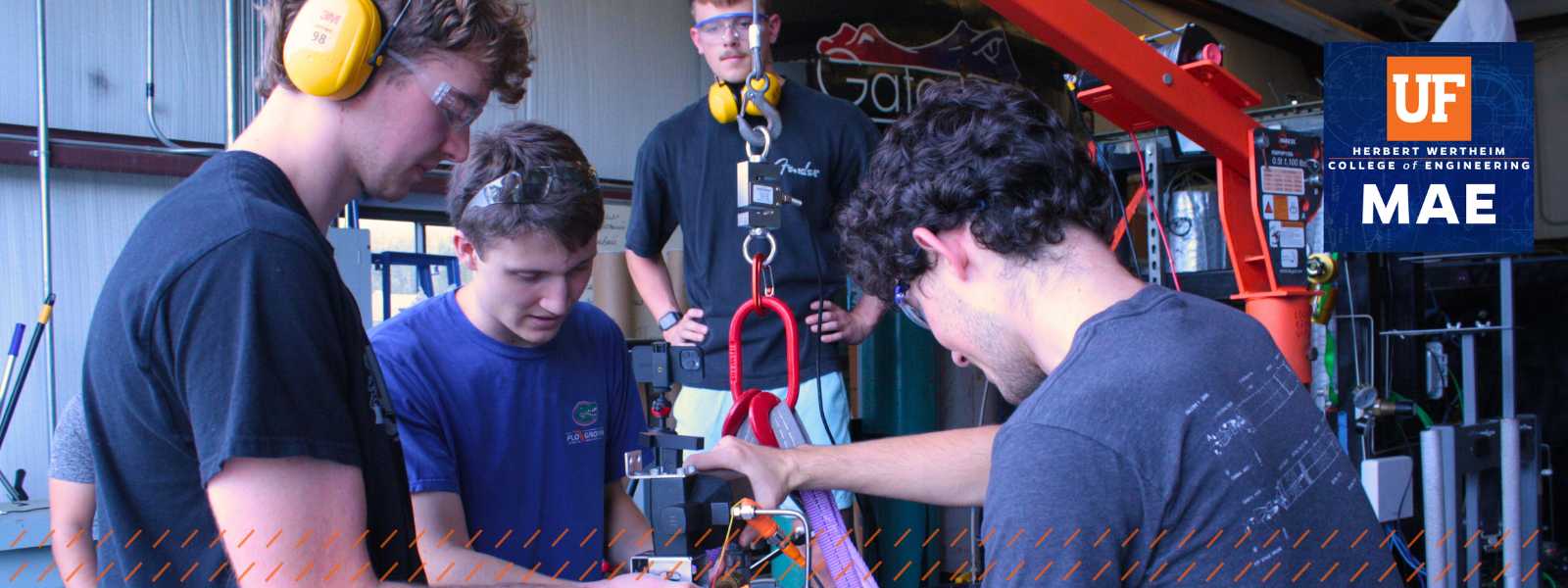 Members of Florida Rocket Lab Student Team work with equipment.