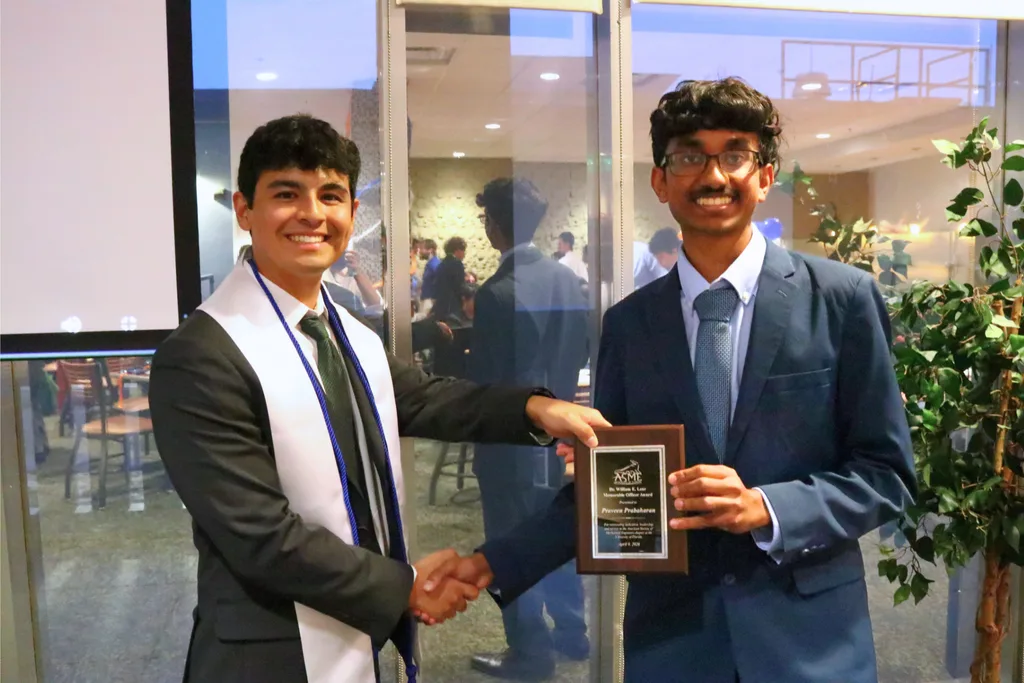 ASME students shaking hands, with Praveen Prabaharan holding award